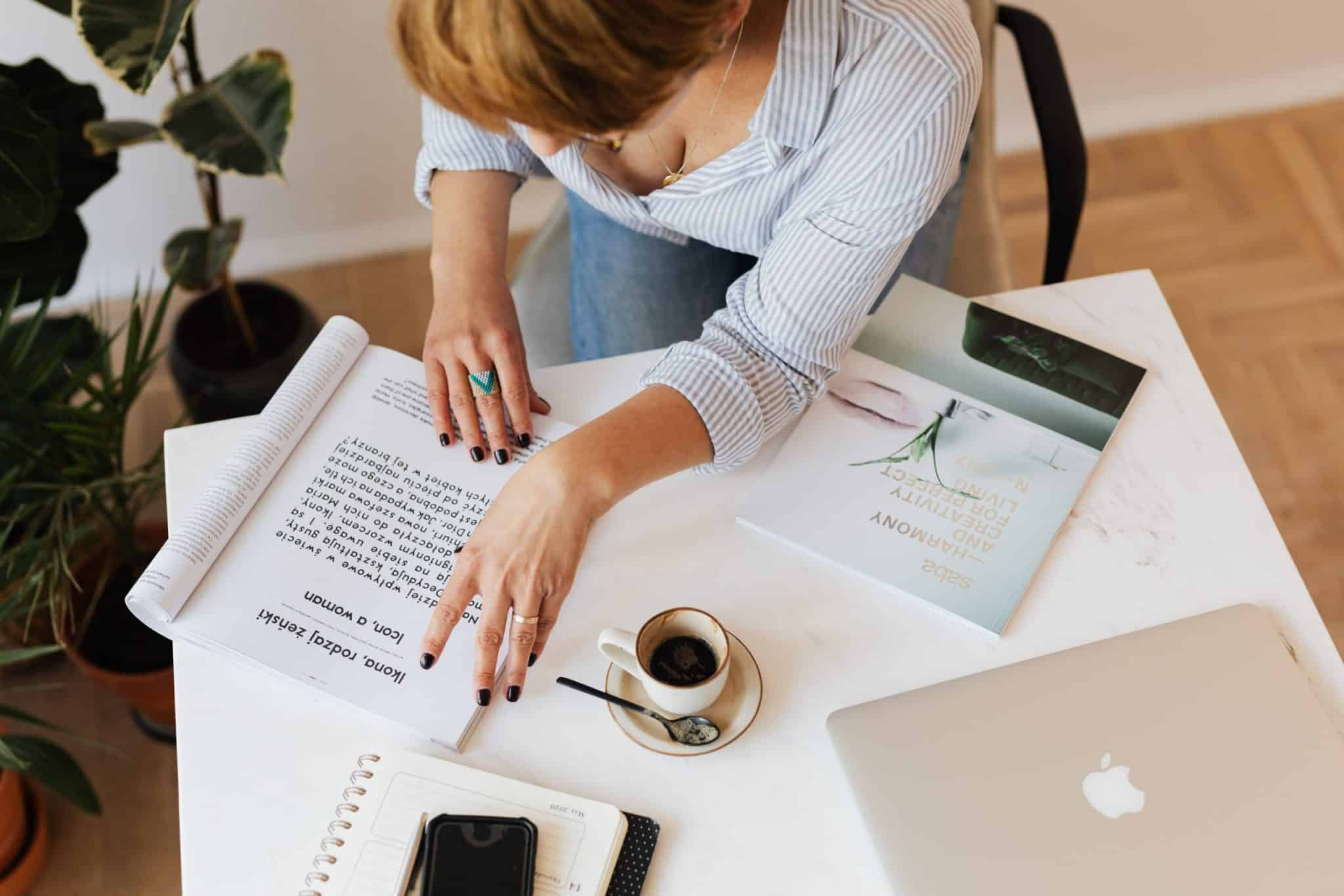 stock-photo-of-woman-reading-magazine-with-folded-pages