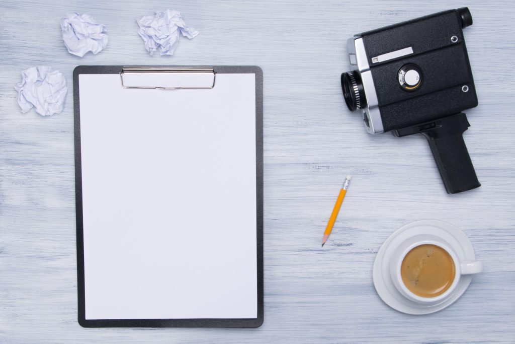 background for the director, a tablet for writing, a coffee mug, for a break and an old black video camera