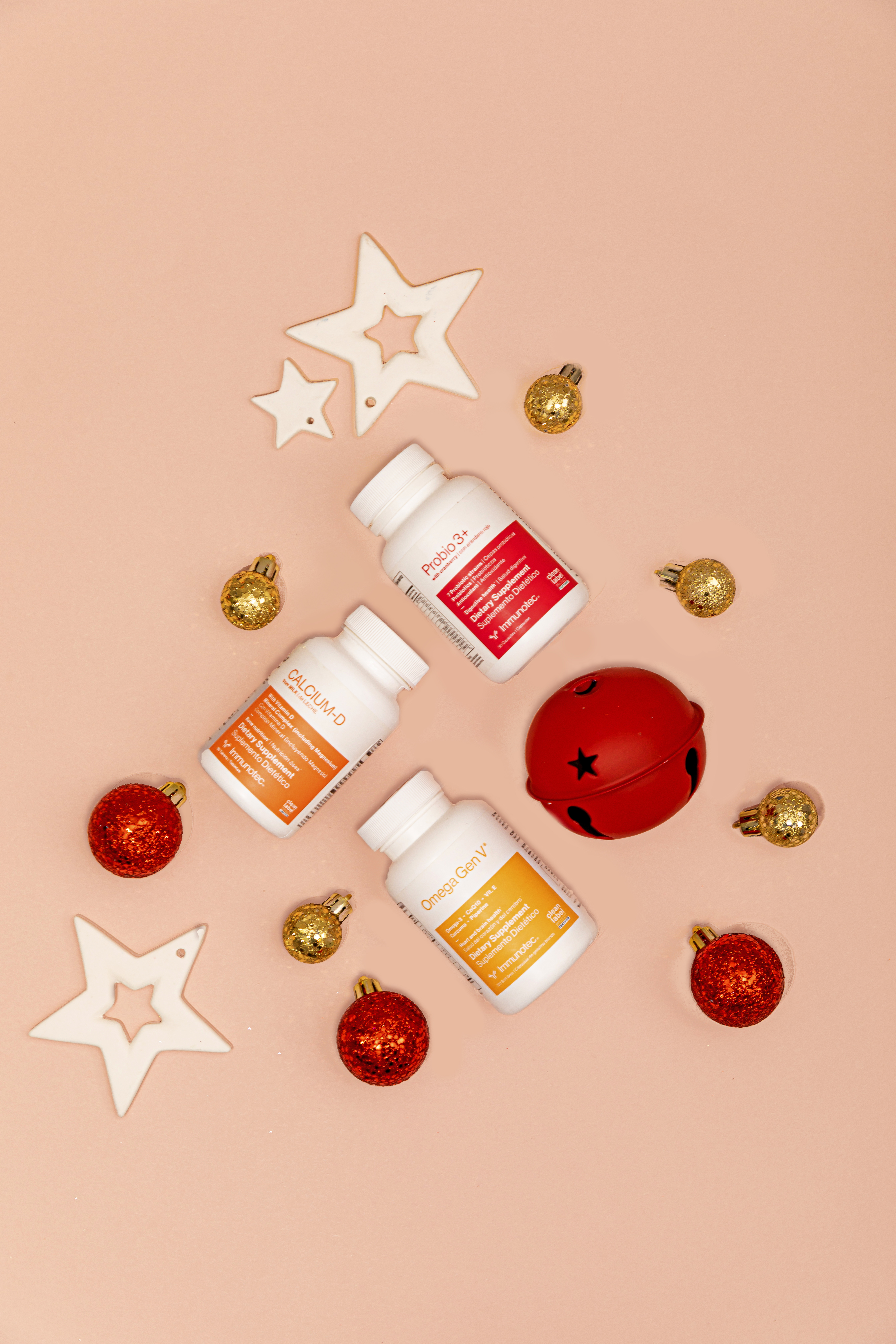 Festive product flat lay of supplement bottles with ornaments - Flocksy