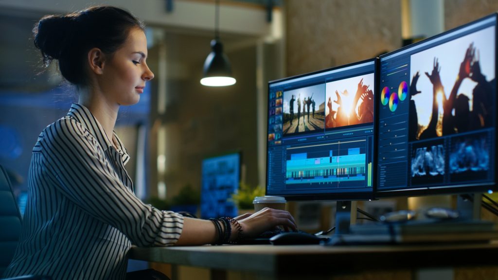 video editor works at computer running a successful video editing project