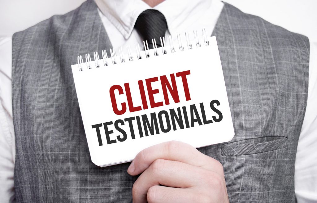 Businessman with notebook with text Client Testimonials . Business concept