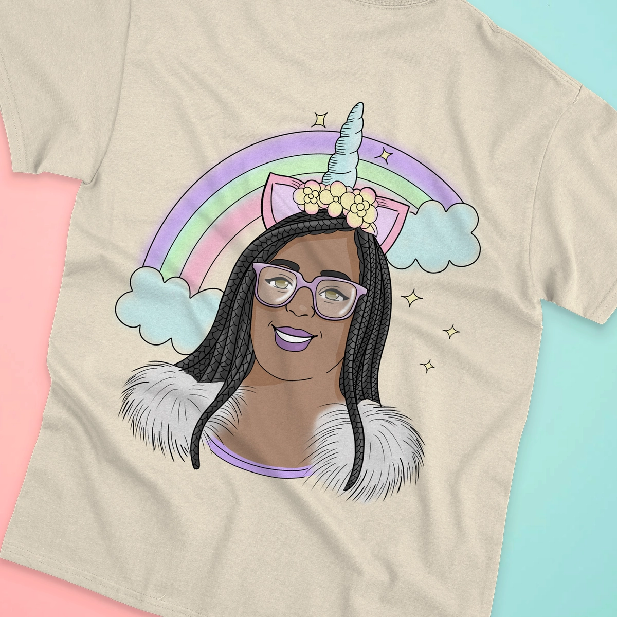 Custom t-shirt mockup designed for The Four-Eyed Marketer - a cream tee printed with an illustrated unicorn portrait of founder Simone Jennings under a pastel rainbow, shot against pink and mint backdrops