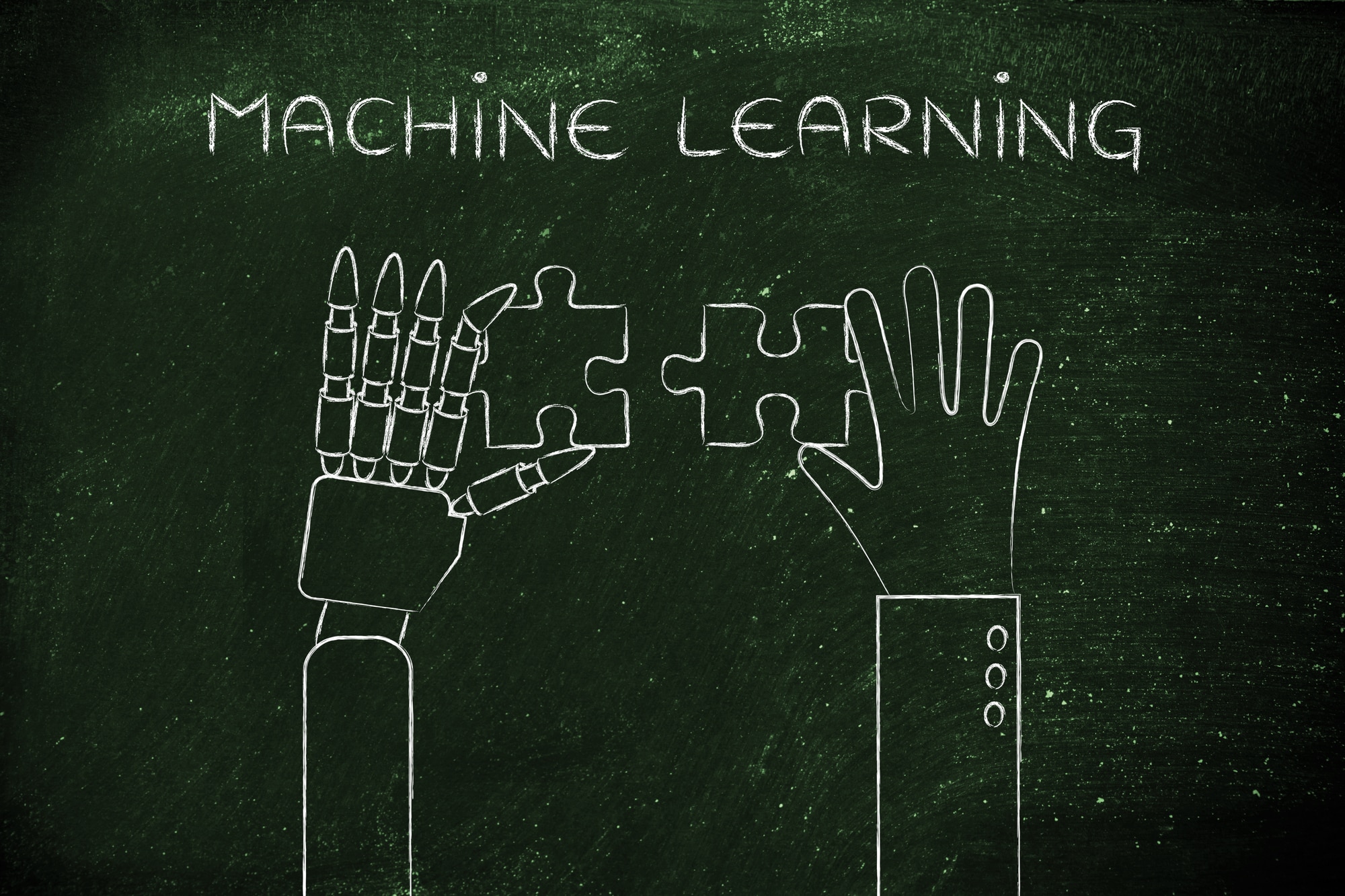 machine learning: human and robot hands solving a puzzle