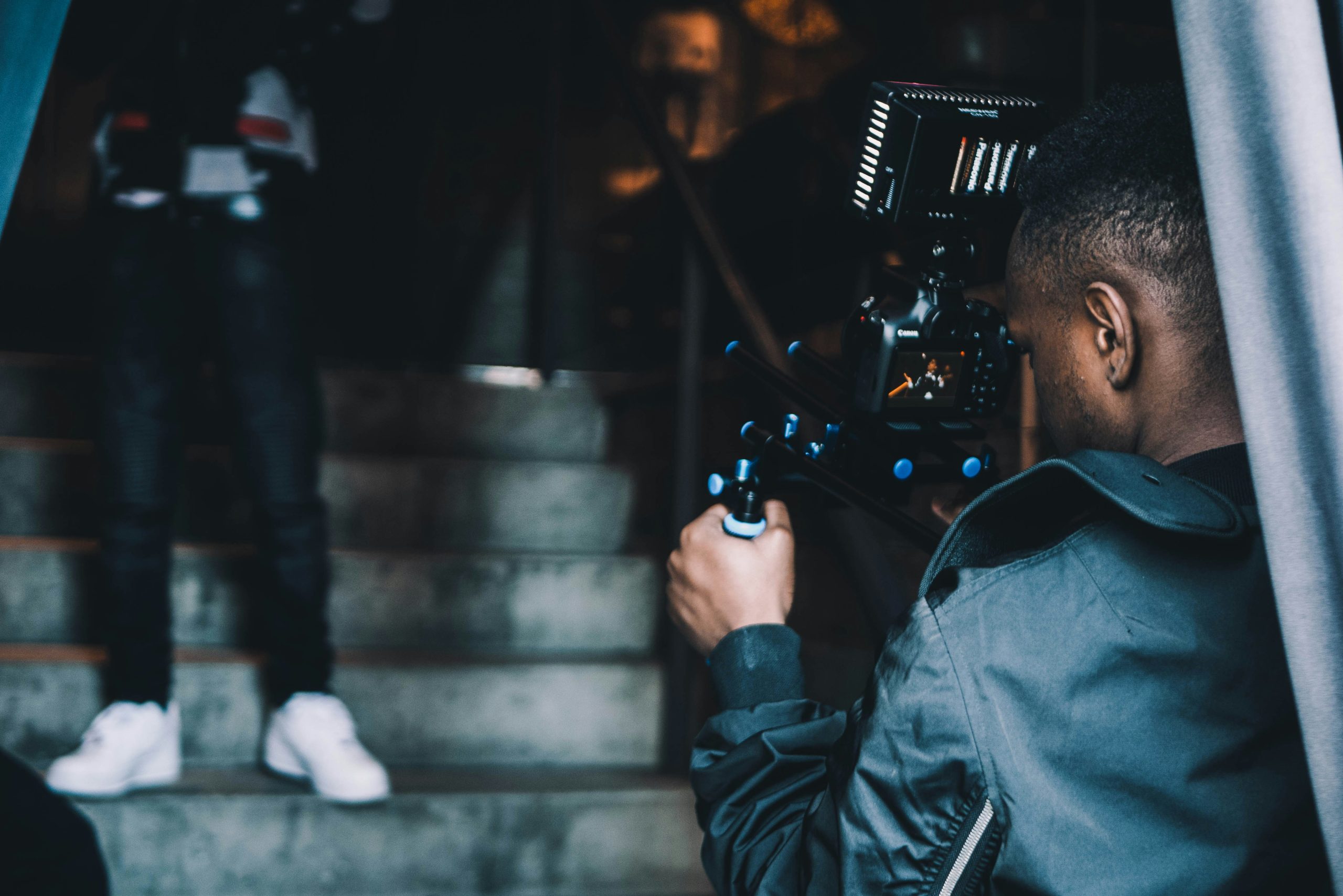 back of person shown filming something