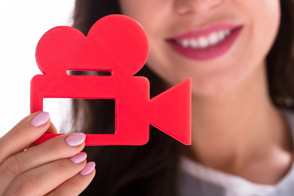 Photo Of Businesswoman's Hand Holding Red Movie Camera