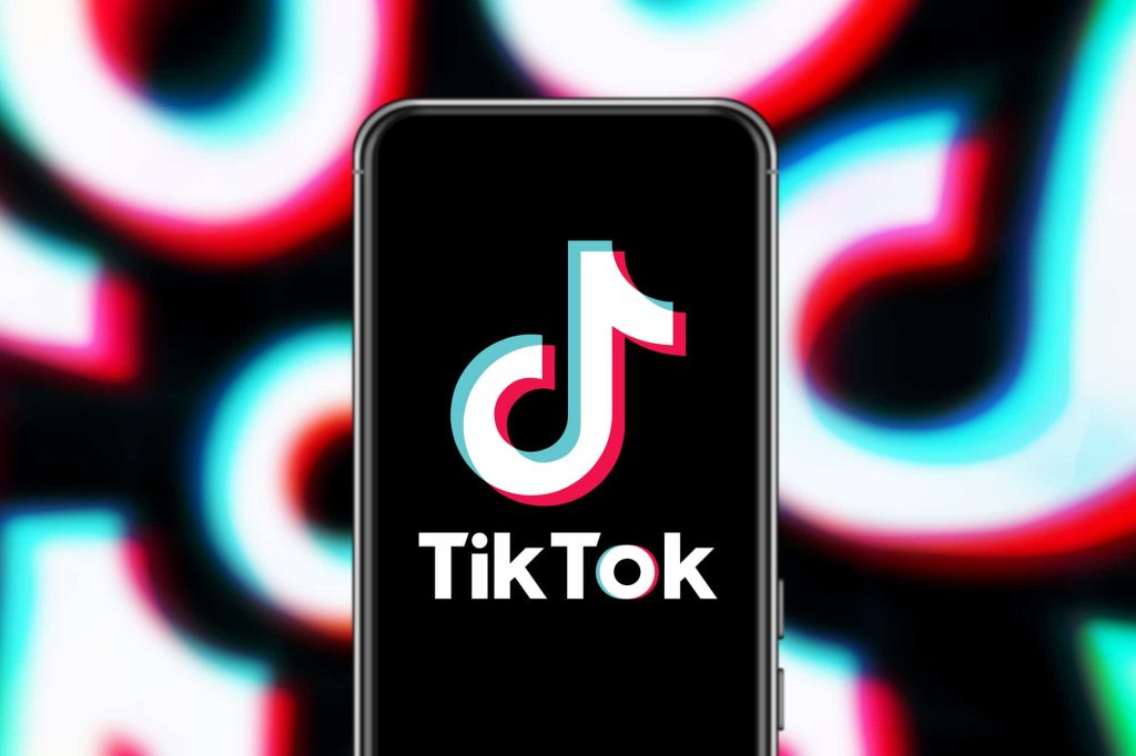 tiktok videos professional videos for tiktok business app open on phone with blurred logo background