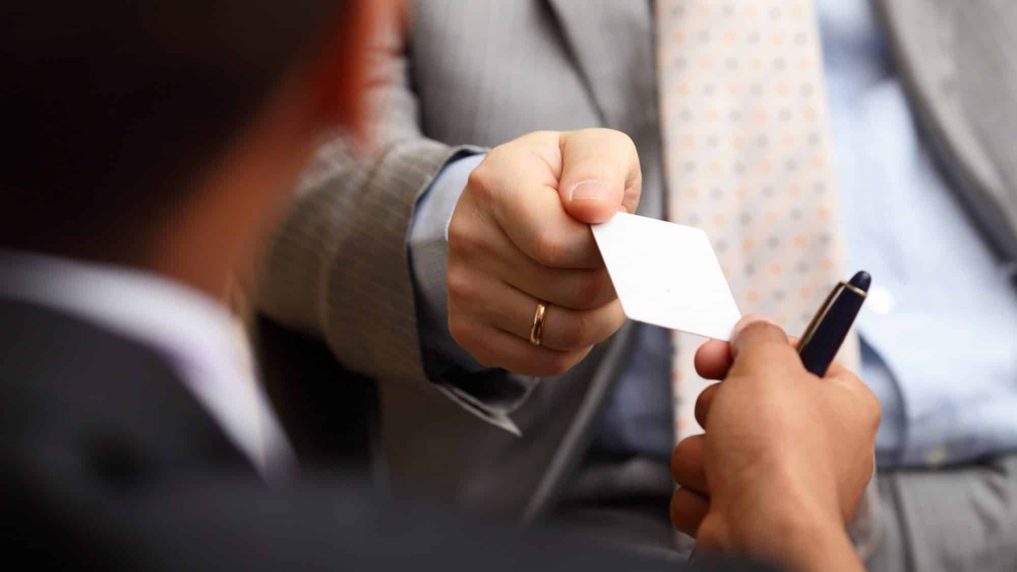 Closeup portrait of two successful business executive exchanging business card