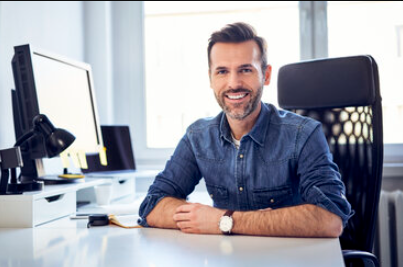 Man sitting in front of a computer at a desk