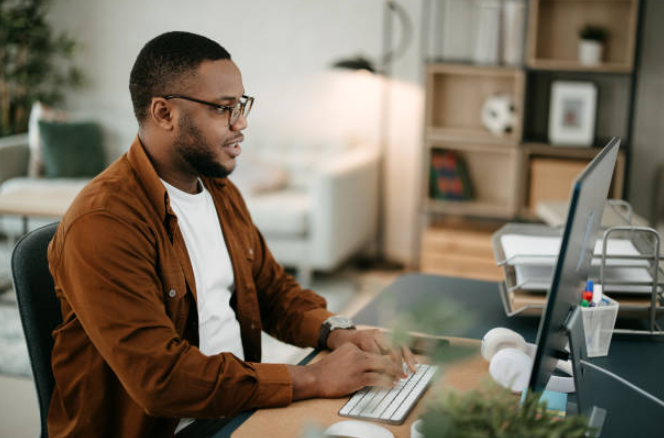 Man sitting at a computer typing