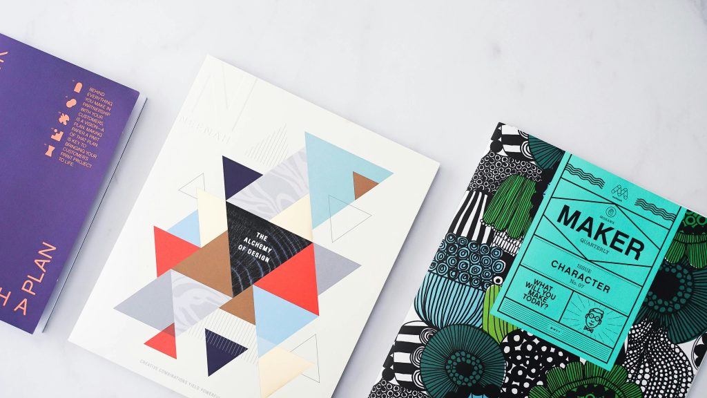 Books about design sitting on a table. 