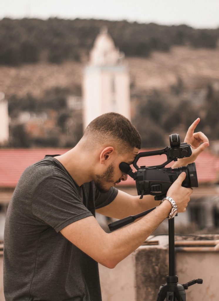 Man looking into a camera and filming