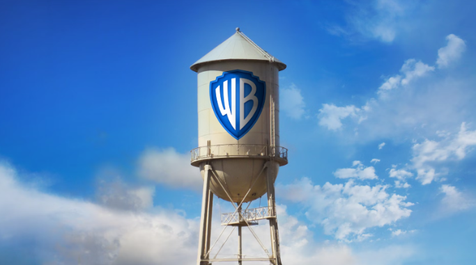A water tower with the text WB on it and blue sky in the background