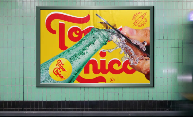 A billboard on the side of a wall the shows a bottle being opened